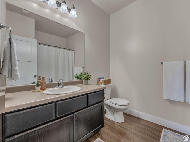 14642 S Mckellen Dr Unit 201, Herriman, UT 84096 - full bathroom with baseboards, wood finished floors, toilet, vanity, and a shower with curtain