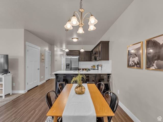 14642 S Mckellen Dr Unit 201, Herriman, UT 84096 - dining space with a chandelier, wood finished floors, and baseboards