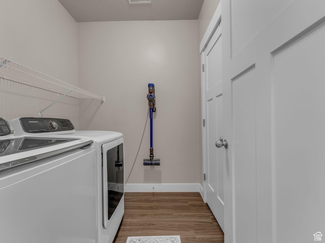 14642 S Mckellen Dr Unit 201, Herriman, UT 84096 - laundry room featuring washer and dryer, wood finished floors, and baseboards