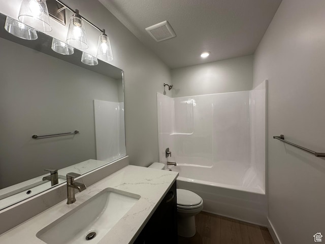 full bathroom featuring toilet, wood finished floors, vanity, shower / tub combination, and recessed lighting