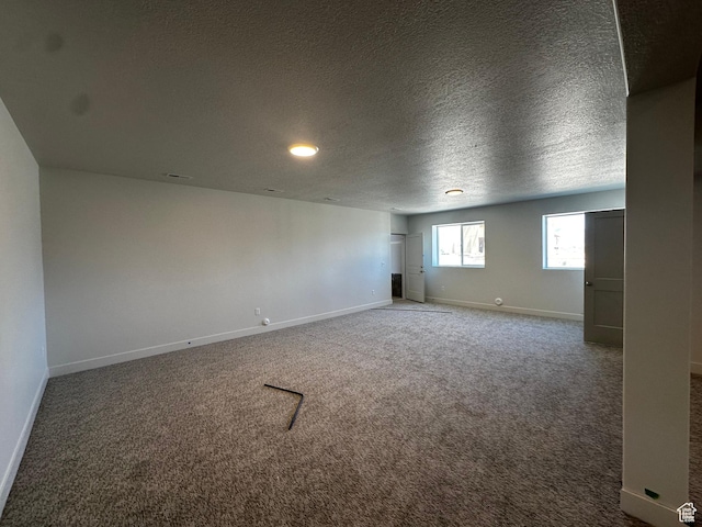 spare room featuring baseboards, carpet floors, a textured ceiling, and recessed lighting