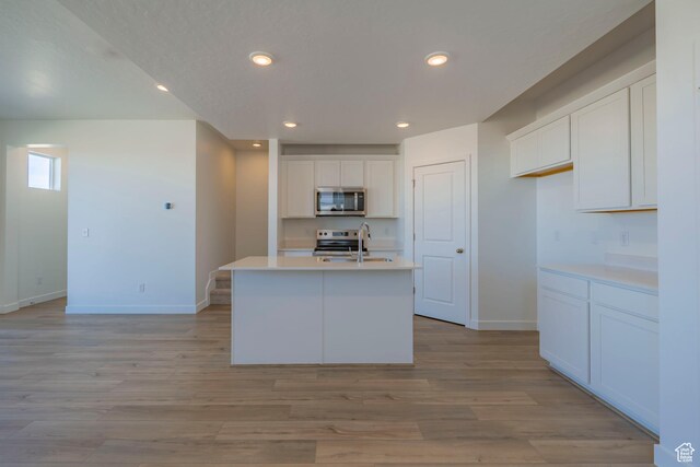 1579 N 800 W, Salem, UT 84653 - kitchen with stainless steel appliances, baseboards, white cabinets, and recessed lighting