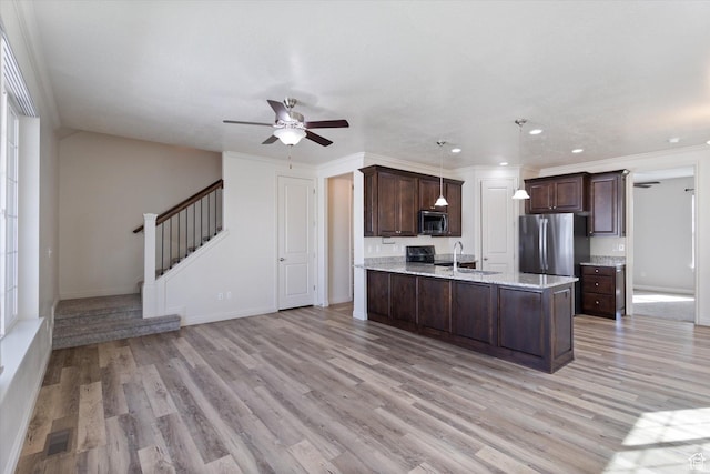 kitchen with stainless steel appliances, ceiling fan, dark brown cabinets, a sink, and recessed lighting