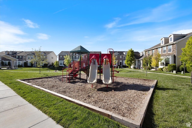 community playground with a residential view and a yard