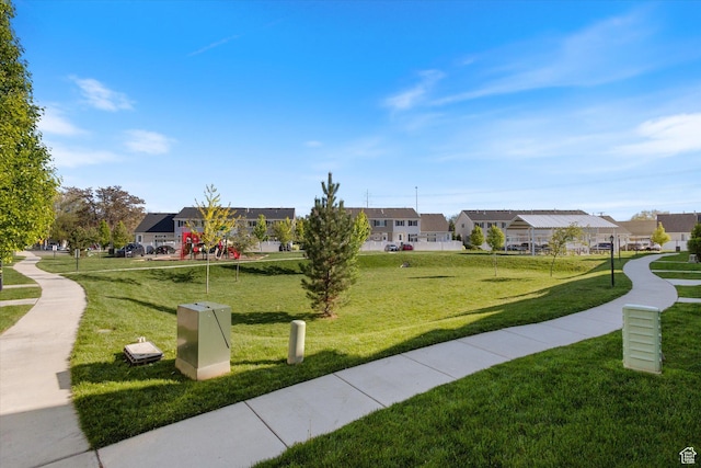 view of property's community with a residential view and a yard