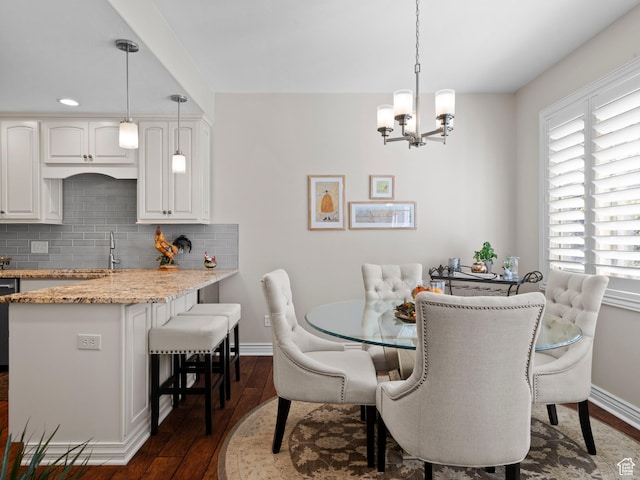 11834 S Cottage View Ln, Draper, UT 84020 - dining space with dark wood finished floors, a chandelier, and baseboards