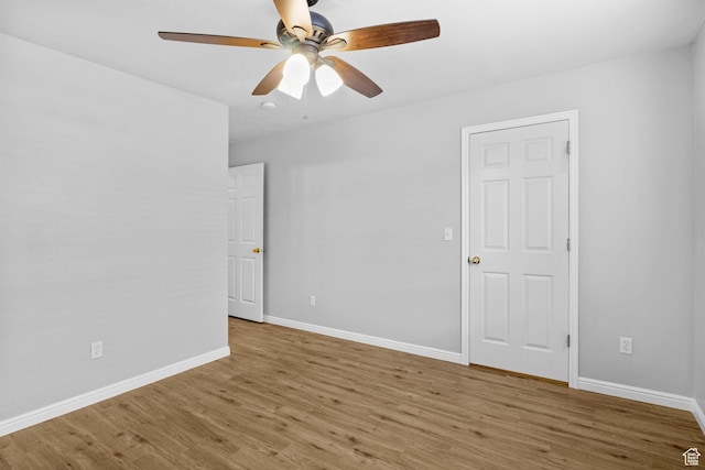 unfurnished room featuring wood finished floors, ceiling fan, and baseboards