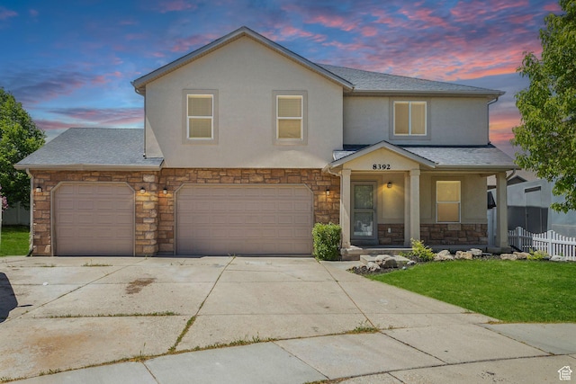 8392 S Oak Vista Dr, West Jordan, UT 84081 - view of front of house featuring stone siding, concrete driveway, stucco siding, a porch, and an attached garage