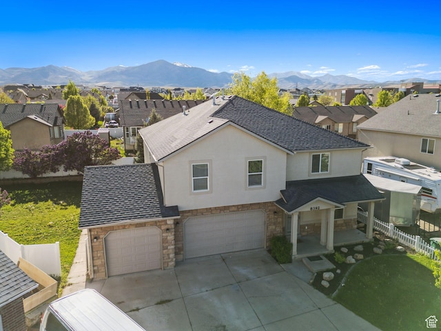 8392 S Oak Vista Dr, West Jordan, UT 84081 - view of front facade with stone siding, an attached garage, fence, stucco siding, and driveway
