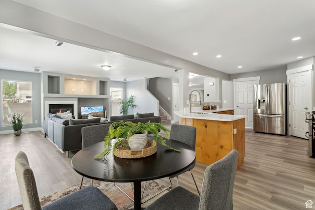 8392 S Oak Vista Dr, West Jordan, UT 84081 - dining area featuring light wood-style flooring, stairway, plenty of natural light, recessed lighting, and baseboards