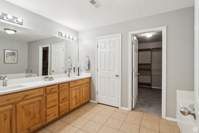 8392 S Oak Vista Dr, West Jordan, UT 84081 - full bathroom with a garden tub, tile patterned floors, double vanity, and baseboards