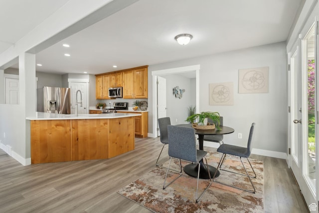 8392 S Oak Vista Dr, West Jordan, UT 84081 - kitchen featuring stainless steel appliances, light wood-style flooring, recessed lighting, a sink, and a peninsula