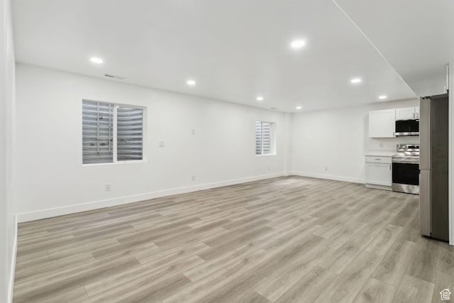 8392 S Oak Vista Dr, West Jordan, UT 84081 - unfurnished living room with recessed lighting, light wood-style flooring, and baseboards
