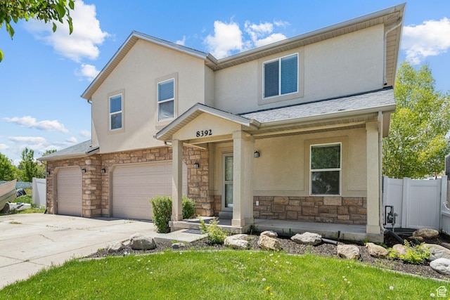 8392 S Oak Vista Dr, West Jordan, UT 84081 - view of front of property with stone siding, a garage, fence, and stucco siding