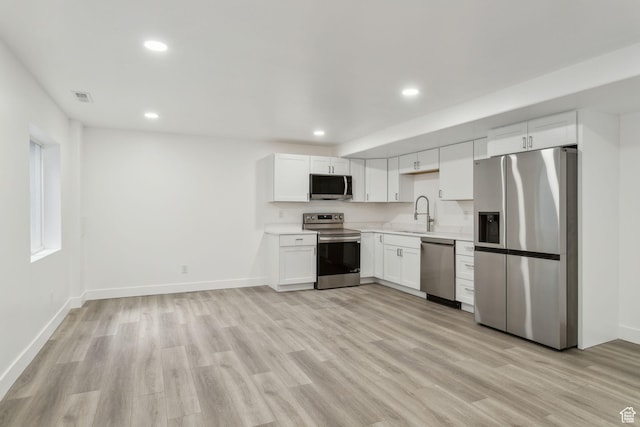 8392 S Oak Vista Dr, West Jordan, UT 84081 - kitchen featuring appliances with stainless steel finishes, light countertops, recessed lighting, light wood-style flooring, and white cabinets