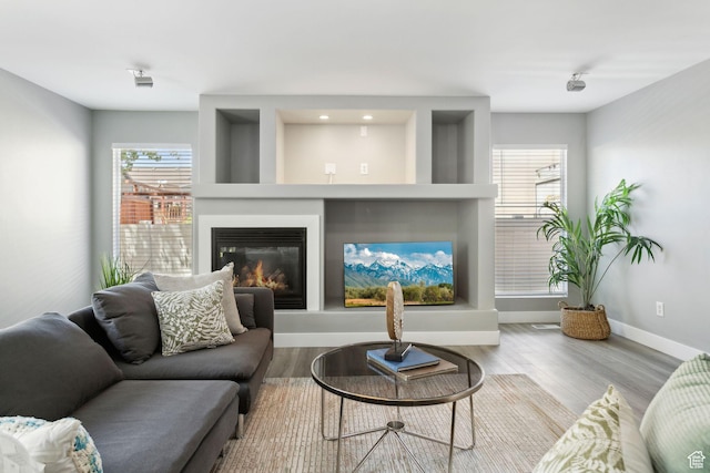 8392 S Oak Vista Dr, West Jordan, UT 84081 - living area with baseboards, wood finished floors, and a glass covered fireplace