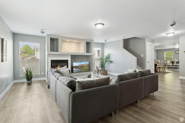 8392 S Oak Vista Dr, West Jordan, UT 84081 - living room featuring wood finished floors, baseboards, and a glass covered fireplace
