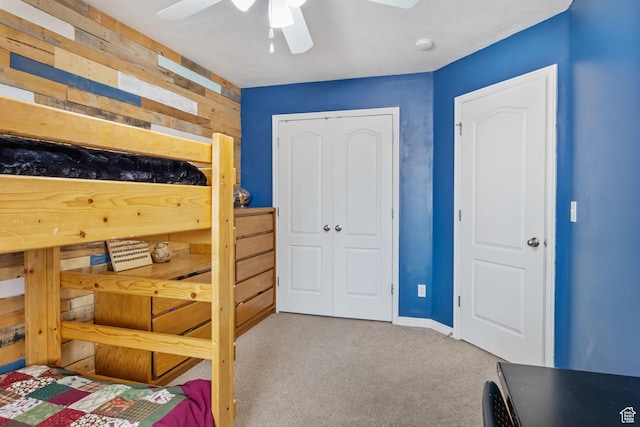 bedroom featuring carpet flooring, a closet, ceiling fan, and baseboards