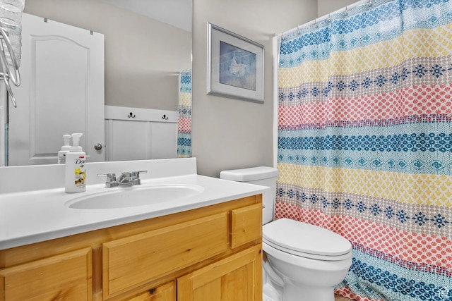 full bathroom featuring toilet, vanity, and curtained shower