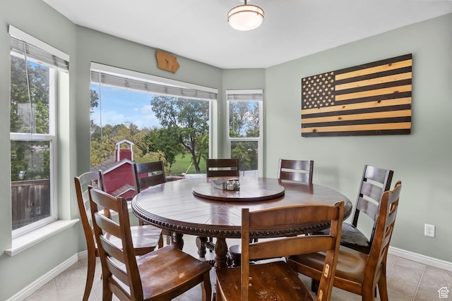 dining room featuring baseboards and light tile patterned floors