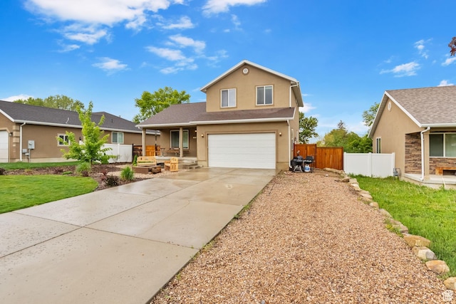 traditional-style house featuring driveway, an attached garage, stucco siding, and a porch