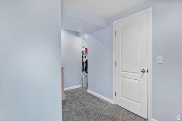 hall with carpet flooring and baseboards