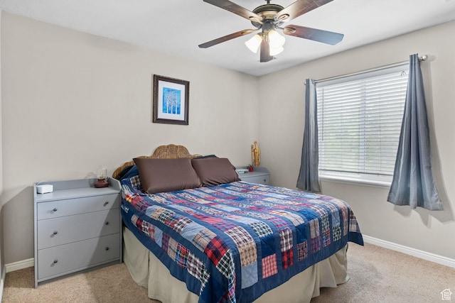 carpeted bedroom with baseboards and ceiling fan