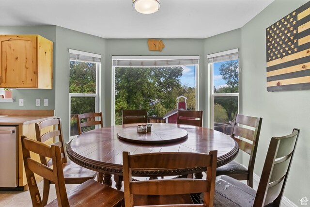 dining area with light tile patterned flooring and baseboards