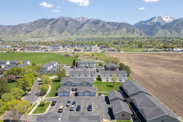 aerial overview of property's location featuring a mountainous background and nearby suburban area