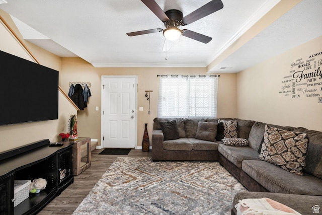 living room featuring ornamental molding, a ceiling fan, and wood finished floors
