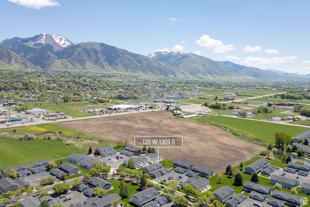 aerial view of property's location with a mountain backdrop and nearby suburban area