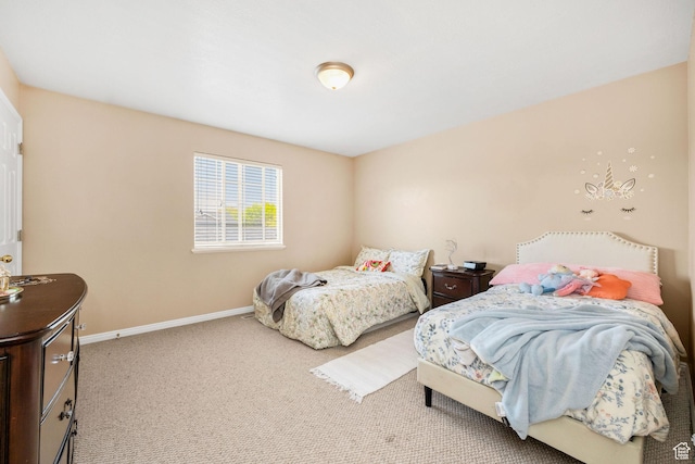 carpeted bedroom featuring baseboards