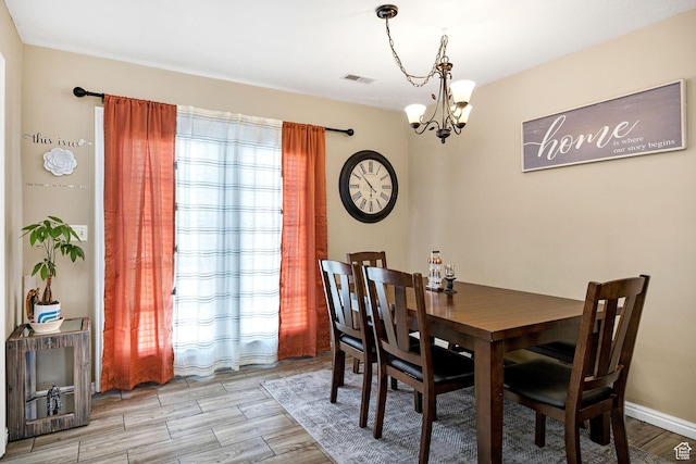 dining room featuring a chandelier and light wood-type flooring