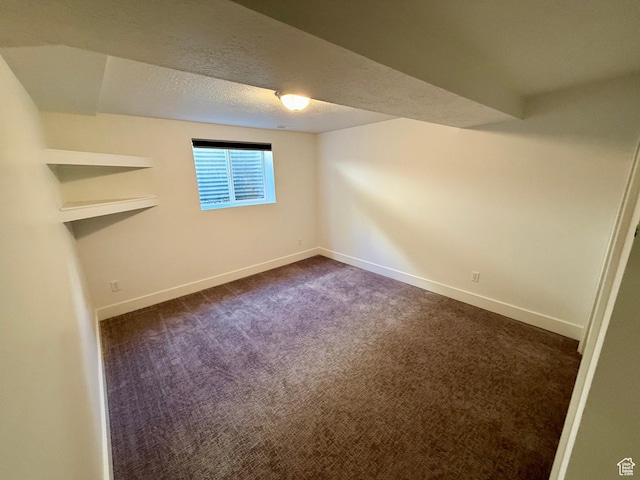 9977 S Lannae Dr E, Sandy, UT 84094 - unfurnished room featuring baseboards, dark carpet, and a textured ceiling