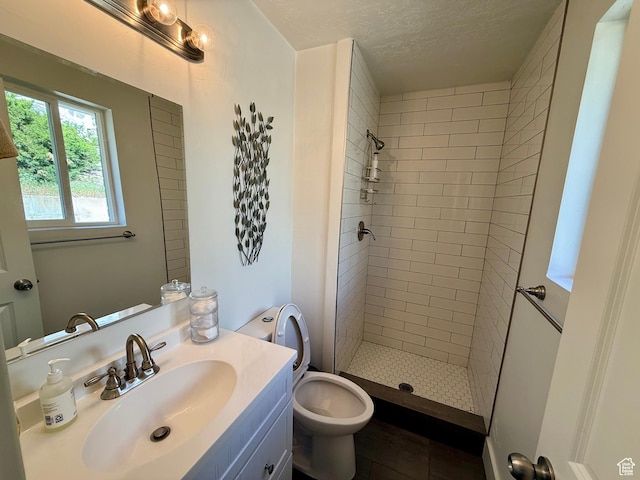 9977 S Lannae Dr E, Sandy, UT 84094 - full bathroom featuring a shower stall, tile patterned floors, vanity, a textured ceiling, and toilet