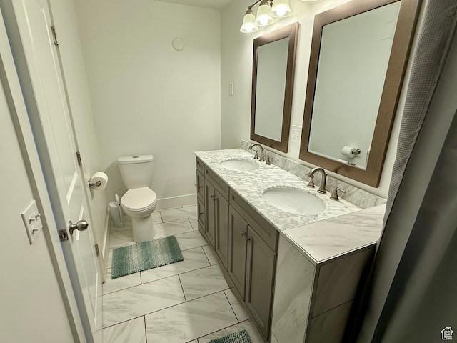 9977 S Lannae Dr E, Sandy, UT 84094 - bathroom with marble finish flooring, toilet, double vanity, and baseboards