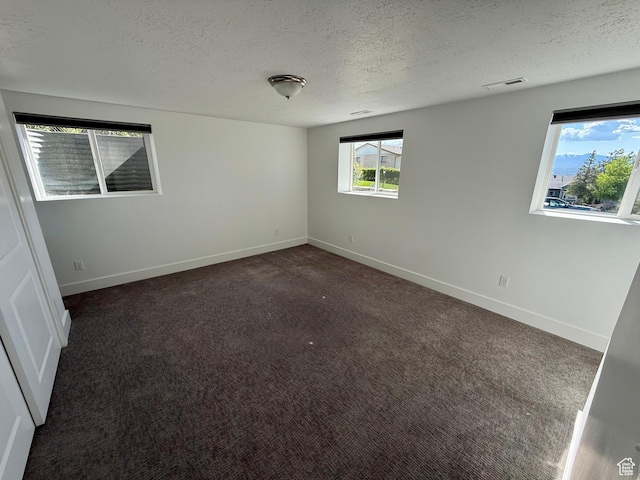 9977 S Lannae Dr E, Sandy, UT 84094 - unfurnished room with a textured ceiling, carpet floors, and baseboards