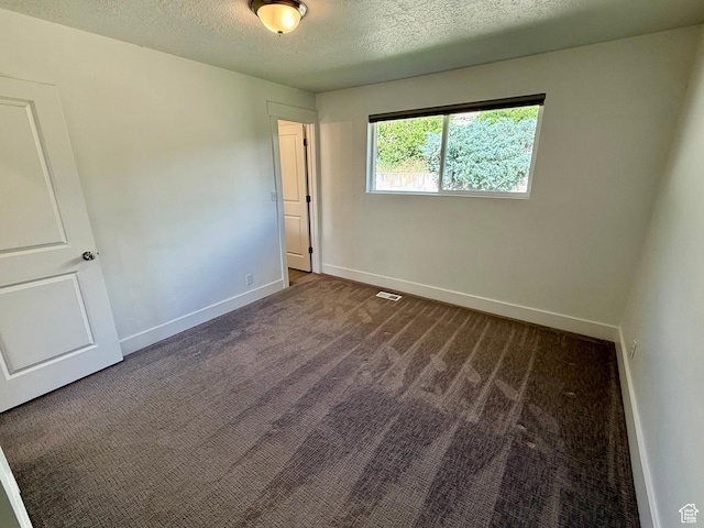 9977 S Lannae Dr E, Sandy, UT 84094 - unfurnished bedroom featuring carpet floors, a textured ceiling, and baseboards