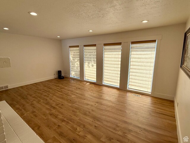 9977 S Lannae Dr E, Sandy, UT 84094 - unfurnished room with recessed lighting, a textured ceiling, baseboards, and wood finished floors