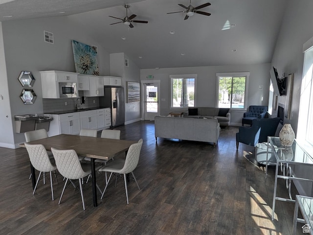 14397 S Hill Shadow Way Unit 87, Herriman, UT 84096 - dining space with high vaulted ceiling, dark wood finished floors, ceiling fan, and baseboards