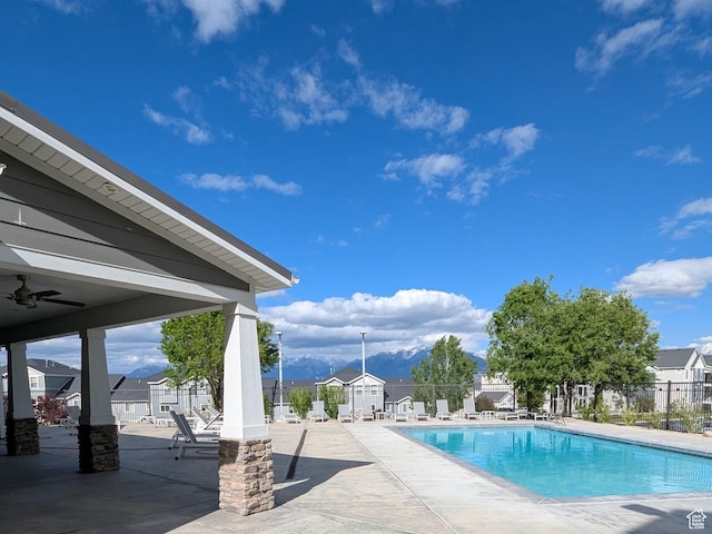14397 S Hill Shadow Way Unit 87, Herriman, UT 84096 - community pool with a patio area, a mountain view, a ceiling fan, and a residential view