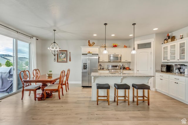 14397 S Hill Shadow Way Unit 87, Herriman, UT 84096 - kitchen featuring stainless steel appliances, recessed lighting, white cabinetry, and a kitchen breakfast bar