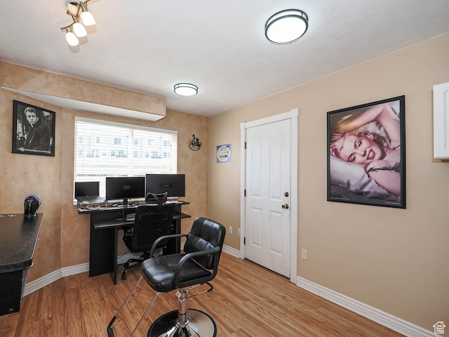 home office with light wood-style floors and baseboards