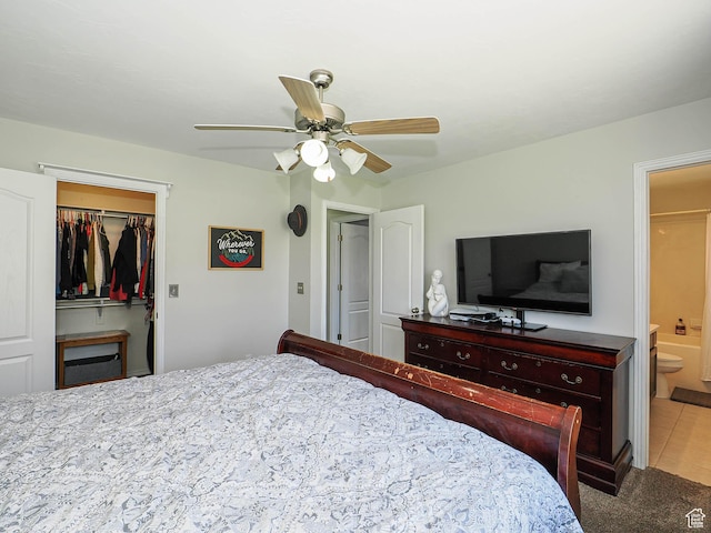 bedroom with ensuite bathroom, carpet flooring, ceiling fan, a closet, and a walk in closet