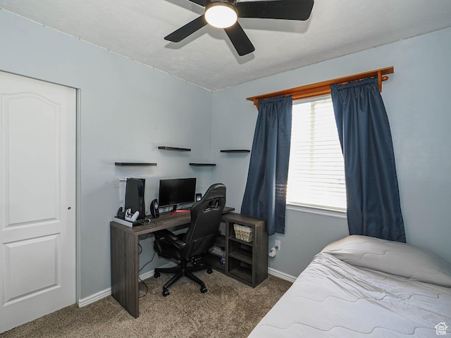 bedroom featuring carpet, baseboards, an office area, and a ceiling fan
