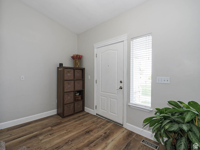 foyer entrance with wood finished floors and baseboards