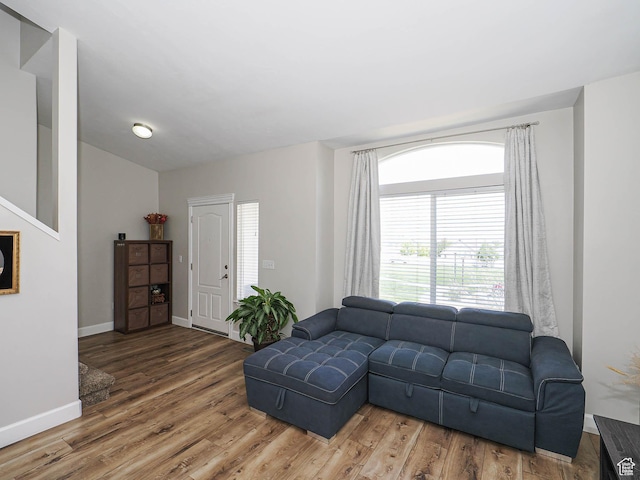 living area with wood finished floors and baseboards