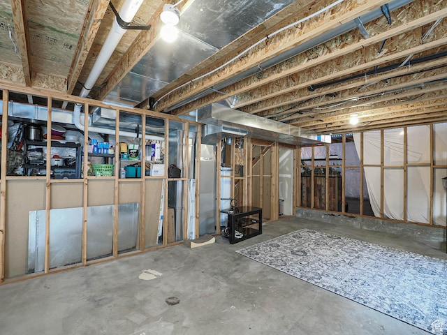 unfinished basement featuring gas water heater