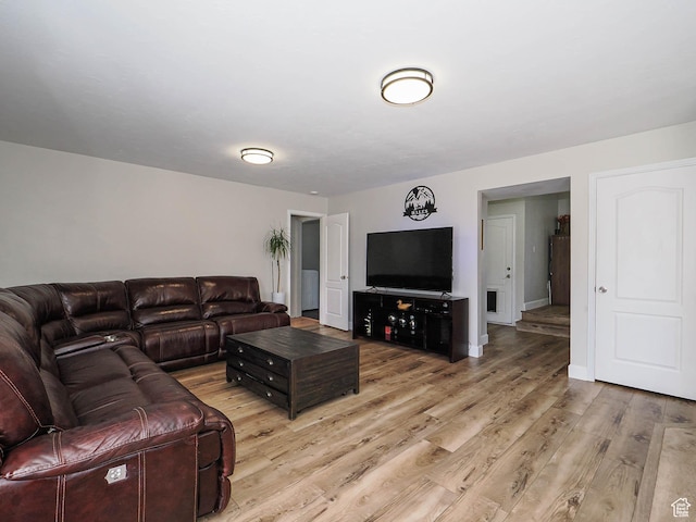 living area featuring light wood finished floors and baseboards