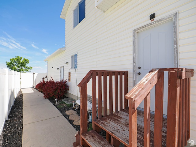 view of exterior entry featuring fence
